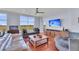 Bright living room featuring hardwood floors, large windows offering scenic views, and comfortable seating at 136 Cooper River Dr, Mount Pleasant, SC 29464