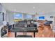 Spacious living room with hardwood floors, large windows, and comfortable seating area with a piano at 136 Cooper River Dr, Mount Pleasant, SC 29464
