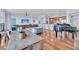 Open concept living and dining area boasting hardwood floors, a piano, and views into the kitchen at 136 Cooper River Dr, Mount Pleasant, SC 29464