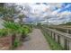 Scenic walking path lined with lush landscaping and providing views of the Ravenel Bridge, creating a serene outdoor experience at 136 Cooper River Dr, Mount Pleasant, SC 29464