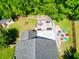 A lush backyard, featuring a fire pit and deck, is beautifully captured from above at 138 Avalon Rd, Summerville, SC 29483