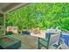 Spacious back deck with outdoor seating, a fire pit, and lush greenery at 138 Avalon Rd, Summerville, SC 29483