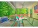 Relaxing back deck with a wicker sofa, fire pit, and colorful seating in the background at 138 Avalon Rd, Summerville, SC 29483