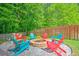 A circular fire pit with Adirondack chairs creates a cozy backyard gathering spot at 138 Avalon Rd, Summerville, SC 29483