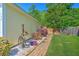 A charming brick pathway leads to a fenced-in backyard with manicured landscaping at 138 Avalon Rd, Summerville, SC 29483