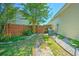 Fenced backyard with stone pathway, green grass, and mature landscaping offering privacy at 138 Avalon Rd, Summerville, SC 29483