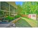 This landscaped backyard offers a screened in porch, shed, and blooming flowers at 138 Avalon Rd, Summerville, SC 29483