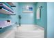 Bathroom featuring a soaking tub, calming blue walls, and a floating shelf for towels at 138 Avalon Rd, Summerville, SC 29483
