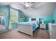 Bright bedroom features a cozy bed with white furniture and tranquil blue walls and vaulted ceiling at 138 Avalon Rd, Summerville, SC 29483