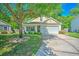 Charming single-story home features a well-manicured lawn, mature shade tree, and a two-car garage at 138 Avalon Rd, Summerville, SC 29483