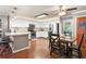 Open kitchen and dining area featuring white cabinets, stainless appliances, island, and dining table at 138 Avalon Rd, Summerville, SC 29483