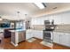 Modern kitchen with white cabinets, stainless steel appliances, granite countertops, and hardwood floors at 138 Avalon Rd, Summerville, SC 29483