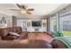 Spacious living room with hardwood flooring, a ceiling fan, a built-in entertainment center and plush brown leather seating at 138 Avalon Rd, Summerville, SC 29483