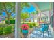 Inviting porch with outdoor seating, colorful flowers, and charming curb appeal at 138 Avalon Rd, Summerville, SC 29483