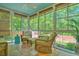 Relaxing screened porch with comfortable seating and views of the lush backyard at 138 Avalon Rd, Summerville, SC 29483