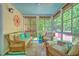 Inviting screened porch with wicker furniture, natural light, and a ceiling fan at 138 Avalon Rd, Summerville, SC 29483
