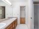 Bright bathroom featuring a double sink vanity, neutral countertop, and a seamless glass shower at 1415 Inland Creek Way, Mount Pleasant, SC 29464
