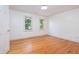 Spacious empty bedroom with hardwood floors and ample natural light from two large windows at 1415 Inland Creek Way, Mount Pleasant, SC 29464