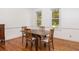 Dining room with hardwood floors, featuring a wooden table and chairs and lots of natural light from two windows at 1415 Inland Creek Way, Mount Pleasant, SC 29464
