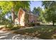 Two-story brick home featuring manicured landscaping and a well-maintained lawn at 1415 Inland Creek Way, Mount Pleasant, SC 29464
