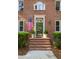 Classic brick home entrance featuring a decorative glass door and manicured shrubbery at 1415 Inland Creek Way, Mount Pleasant, SC 29464