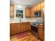 Kitchen featuring updated stainless steel appliances, including a range and microwave, with wood cabinets at 1415 Inland Creek Way, Mount Pleasant, SC 29464