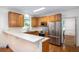Kitchen with wooden cabinets, stainless steel appliances, and a breakfast bar overlooking an adjacent living area at 1415 Inland Creek Way, Mount Pleasant, SC 29464