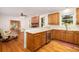 Kitchen with wooden cabinets, stainless steel appliances, breakfast bar, and view into an adjacent living area at 1415 Inland Creek Way, Mount Pleasant, SC 29464
