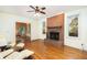 Spacious living room featuring a brick fireplace, hardwood floors, and natural light at 1415 Inland Creek Way, Mount Pleasant, SC 29464