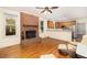 Open-concept living space with a brick fireplace and an adjacent kitchen with stainless steel appliances at 1415 Inland Creek Way, Mount Pleasant, SC 29464
