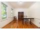 Bright office space with hardwood floors, a desk, bookcase, and lots of natural light from two large windows at 1415 Inland Creek Way, Mount Pleasant, SC 29464