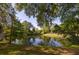 Scenic pond view with lush greenery, mature trees, and calm waters, enhancing the property's natural beauty at 1415 Inland Creek Way, Mount Pleasant, SC 29464