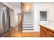 A view of the staircase with stainless steel refrigerator in the background at 1415 Inland Creek Way, Mount Pleasant, SC 29464