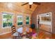 Cozy sunroom with wood-paneled walls, lots of windows, and a charming breakfast table at 1415 Inland Creek Way, Mount Pleasant, SC 29464