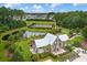 Aerial view featuring a pavilion, lake, tennis courts, and lush greenery in a well-planned community at 1488 Croaton Crsg, Mount Pleasant, SC 29466