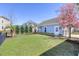 Landscaped backyard featuring manicured lawn, black fence, and a detached garage at 1488 Croaton Crsg, Mount Pleasant, SC 29466