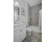 Well-lit bathroom features tiled shower and floors, and a white vanity at 1488 Croaton Crsg, Mount Pleasant, SC 29466
