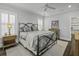 Charming bedroom features an ornate bed frame, shuttered windows, and neutral colors at 1488 Croaton Crsg, Mount Pleasant, SC 29466