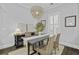 Elegant dining room with a modern light fixture, stylish table setting, and neutral wall decor at 1488 Croaton Crsg, Mount Pleasant, SC 29466