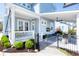 Home exterior featuring a covered patio with outdoor seating, ceiling fans, and a manicured lawn at 1488 Croaton Crsg, Mount Pleasant, SC 29466