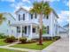 Charming two-story home with a landscaped yard and inviting front porch featuring a palm tree at 1488 Croaton Crsg, Mount Pleasant, SC 29466