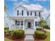 Inviting two-story home with a welcoming front porch, complemented by well-maintained landscaping at 1488 Croaton Crsg, Mount Pleasant, SC 29466
