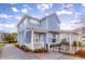 Exterior rear view of a charming home, featuring a cozy patio with a privacy fence and attached garage at 1488 Croaton Crsg, Mount Pleasant, SC 29466
