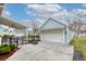 Detached light blue garage with a white door, basketball hoop, and a covered outdoor area at 1488 Croaton Crsg, Mount Pleasant, SC 29466