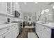 Open kitchen with stainless appliances, white cabinets, and a clear view into the adjacent dining area at 1488 Croaton Crsg, Mount Pleasant, SC 29466