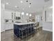 Stylish kitchen with white cabinets, a blue island with seating, and modern pendant lighting at 1488 Croaton Crsg, Mount Pleasant, SC 29466