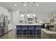 Modern kitchen with an island featuring barstool seating, stainless steel appliances, and white cabinets at 1488 Croaton Crsg, Mount Pleasant, SC 29466