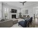 Cozy living room with a fireplace, neutral-toned sofas, and plantation shutters at 1488 Croaton Crsg, Mount Pleasant, SC 29466