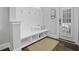 Mudroom featuring a shiplap wall with hooks, bench, storage cubbies and wood floors at 1488 Croaton Crsg, Mount Pleasant, SC 29466