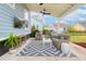 Covered outdoor patio featuring comfortable seating, ceiling fans and lush landscaping at 1488 Croaton Crsg, Mount Pleasant, SC 29466